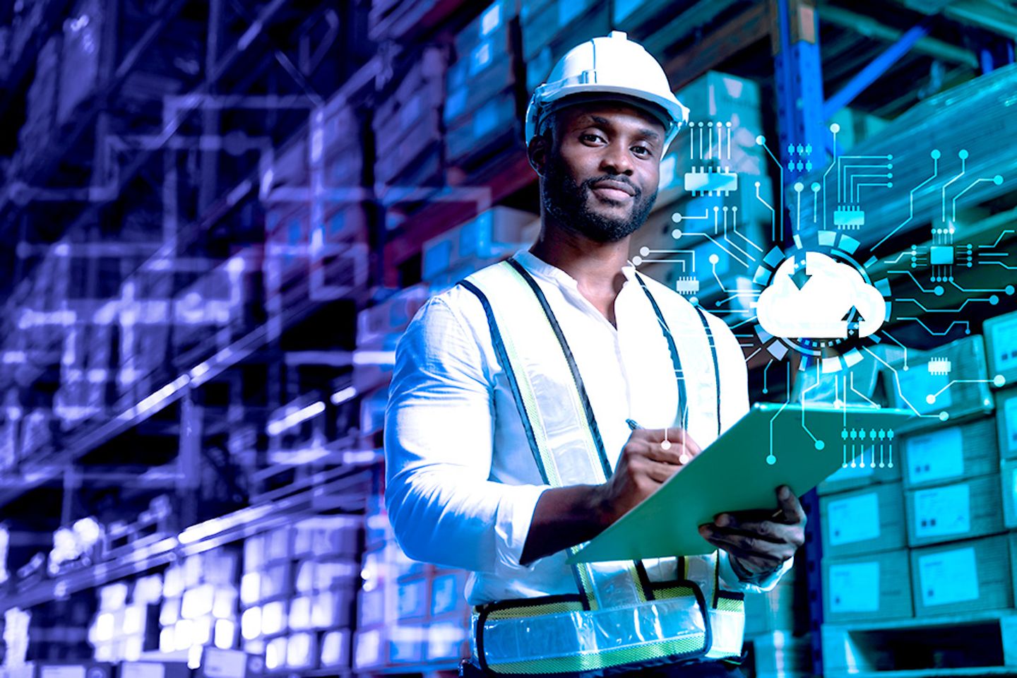 Male staff checking stock on cloud computing system in a smart logistic factory